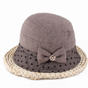 Close-up of vintage brown bow hat with polka dots and a golden flower rhinestone detail