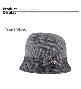 Detailed view of women's houndstooth cloche hat with bow and floral metal accent