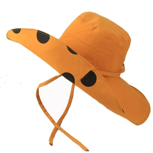 Detail of orange wide brim sun hat with large black polka dots and windproof strap