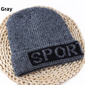 Detailed shot of gray knitted beanie showing the Sport logo and ribbed wool texture