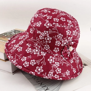 Close-up of dark red floral bucket hat with fabric flower and pearl detail