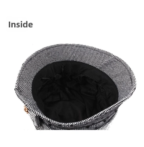 Detail view of winter cloche hat interior with adjustable black straps and tweed texture