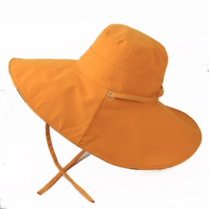 Close-up of bright orange wide-brim sun hat with matching windproof chin strap