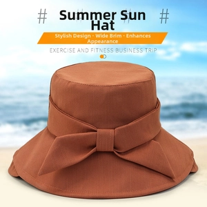 Detailed view of dark brown wide brim sun hat with elegant bow and cotton linen texture