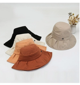 Top view of five solid color wide brim sun hats with decorative buckles in multiple colors