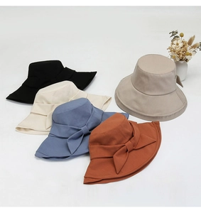 Detail view of cotton-linen sun hats with bow decoration in five different colors