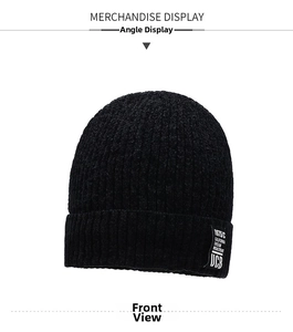 Detailed texture of black knit beanie featuring vertical stripes and California patch