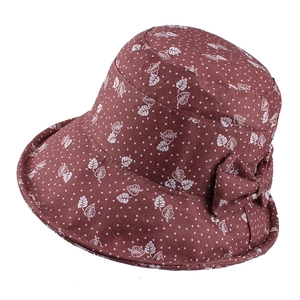 Detail of floral maple leaf print and bow on dark brown autumn sun hat bucket cap