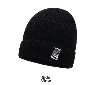 Close-up of black knit beanie featuring a white logo patch and thick ribbed texture