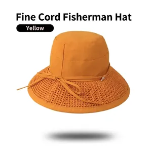Women's yellow sun hat with mesh brim and ribbon bow tie on white background