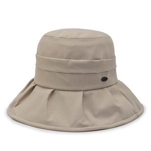 Close-up of khaki bucket hat with pleated band and small oval brand tag detail