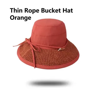 Orange summer sun hat with hollow weave brim and decorative bow for beach and travel