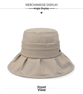 Close-up of beige sun hat detailing cotton-linen fabric and decorative side button