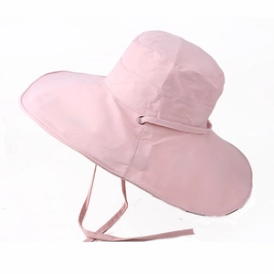 Detail of light pink wide brim sun hat showing adjustable chin strap and metal eyelets