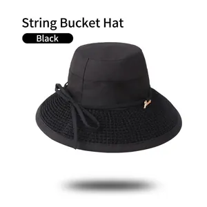 Detail of black cotton bucket hat showing woven brim texture and thin decorative cord