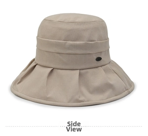 Detailed macro view of beige sun hat with textured fabric and elegant side buckle