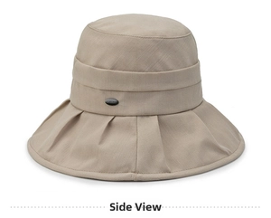 Detail view of khaki cotton bucket hat with breathable fabric texture and metal plaque