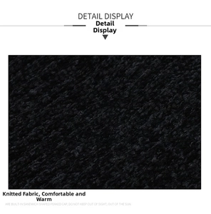 Close-up of thick black jacquard knit fabric showing warm texture and detail display