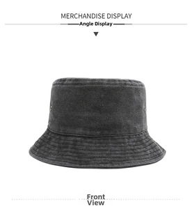 Detailed view of dark grey washed denim bucket hat with metallic eyelets and stitched brim
