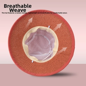 Detail view of the breathable mesh lining inside a woven summer sun hat in brown orange