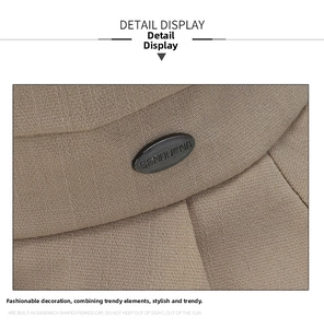 Close-up of khaki twill cotton fabric with a black oval metal logo on the sun hat