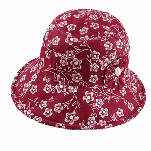 Floral print burgundy bucket hat with decorative fabric flower and cream pearl accent