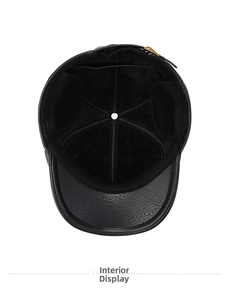 Detail view of the warm fleece lining and reinforced seams inside the black leather winter cap