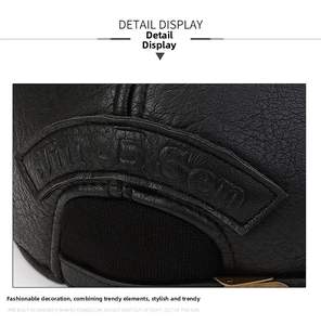Close-up of black litchi grain leather baseball cap with metal buckle and neat stitching