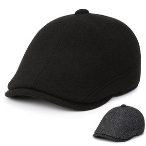 Close-up of black and dark grey wool blend flat cap showing premium tweed texture