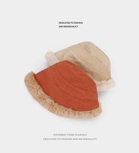 Detail view of winter bucket hats in caramel and beige with plush faux fur trim