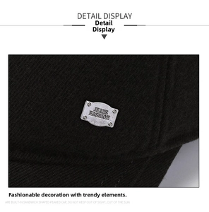 Detail of winter baseball cap showing diagonal twill texture and silver metal brand plate