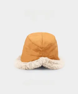 Detail of winter ginger yellow bucket hat featuring thick cream faux fur trim and warm cotton