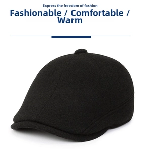Detail showing the thick black wool blend fabric and crown button of the winter earflap cap