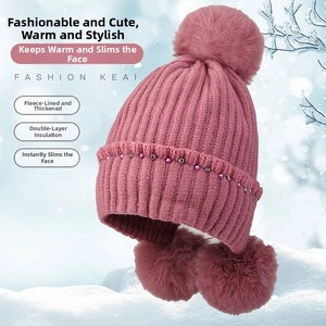 Detail of dust pink knit hat showing warm fleece lining and crystal leaf ornaments