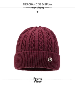 Detail showing cable-knit texture and circular number 5 emblem on a warm winter beanie
