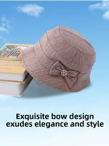 Close-up of elegant reddish-brown woven cloche hat with a bow and golden metal buckle