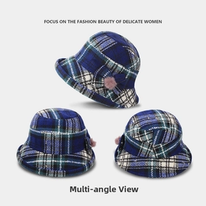 Multiple views of blue plaid wool bucket hat with bow and pink faux fur pompom detail