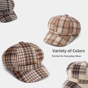 Flat lay of wool newsboy caps in houndstooth and tartan patterns with earthy tones