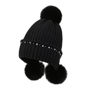 Black ribbed knit winter hat with fluffy rabbit fur pom-poms and crystal rhinestones