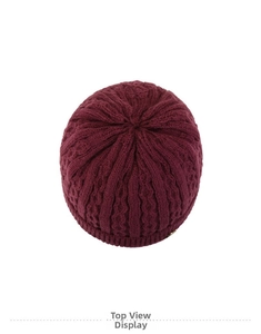 Detailed top view showing thick cable knit texture of a wine red winter beanie hat