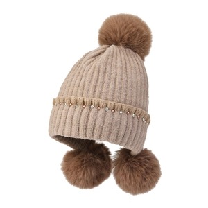 Women's knitted winter hat with faux fur balls and pearl rhinestone decorations