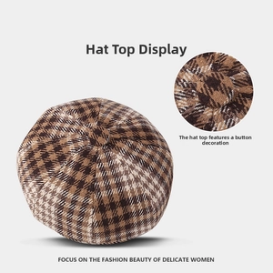 Close-up of the vintage houndstooth pattern and top button detail on the octagonal cap