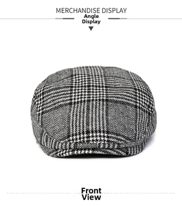 Front view of classic black and white houndstooth beret hat with a structured short brim