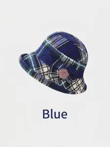 Detail view of winter plaid bucket hat in blue wool blend with decorative bow and pompom