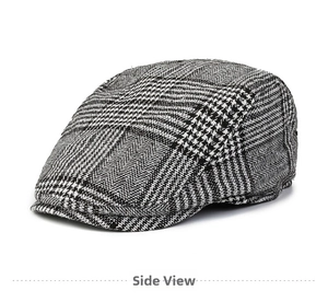 Detail view of stylish black and white houndstooth wool flat cap from a side angle