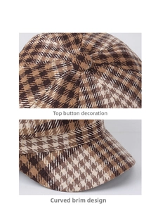 Close-up of houndstooth newsboy cap showing top button and curved brim details