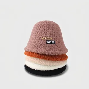 Winter plush bucket hats in five colors with embroidery patch stacked on gray background