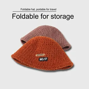 Foldable plush sherpa bucket hats for women in orange and brown with retro patches