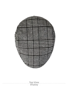 Overhead view showing black and white plaid pattern and fabric texture of the beret cap