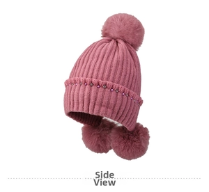 Detail view of pink knitted earmuff hat with plush pom-poms and pearl rhinestone trim